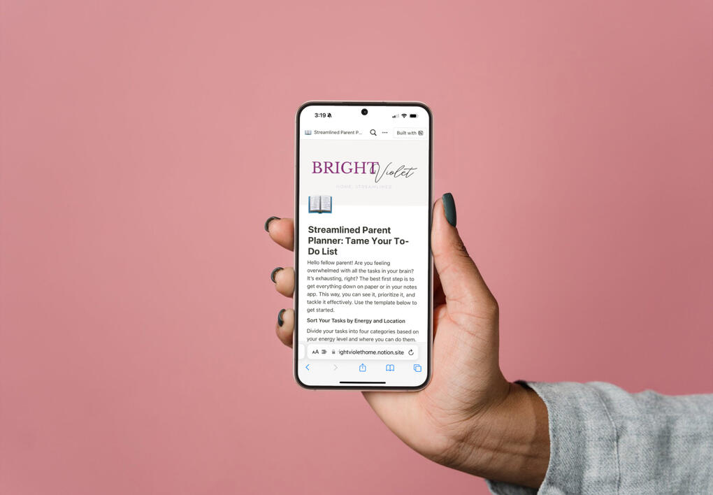 Photo of free planner on an iPhone held in a hand toward facing toward viewer.